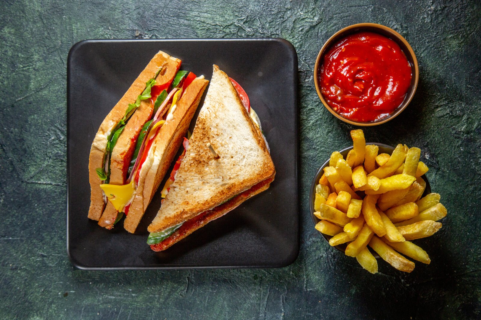 top-view-yummy-ham-sandwich-inside-dark-plate-with-french-fries-ketchup-dark-surface